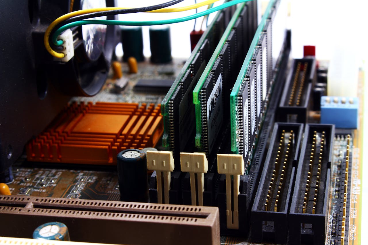 about-us Detailed view of computer motherboard featuring RAM, chipset, and wiring.